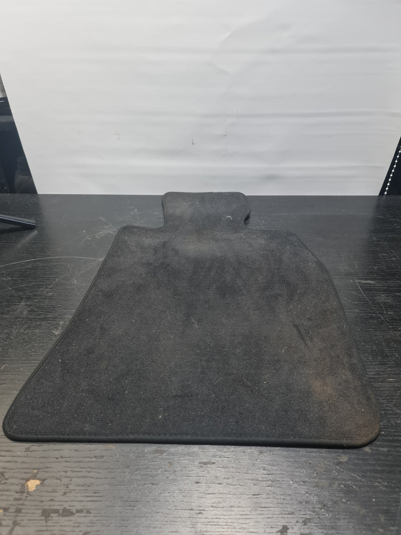 Genuine BMW M3 G80 velour carpet floor mats in charcoal, branded MPerformance.parts, showing close-up of textured surface and edges.