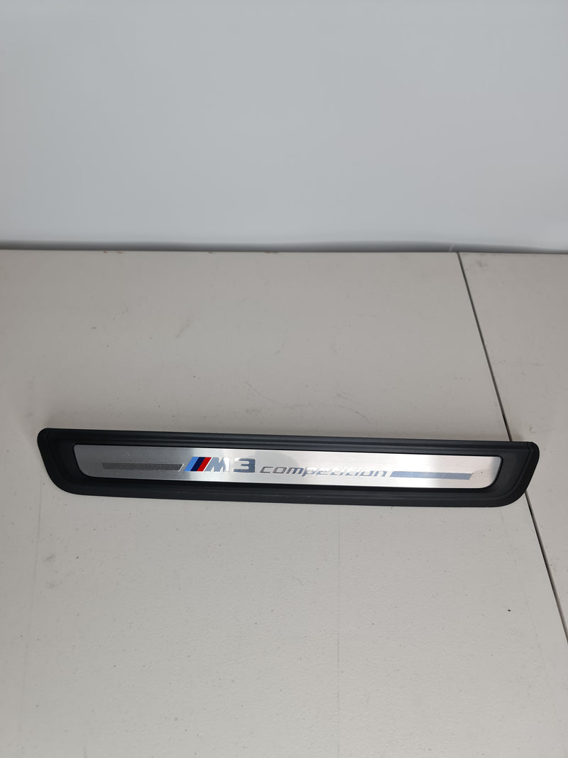 BMW G80 M3 Competition OEM front door sill kick plate by MPerformance.parts, showing the sleek metal finish and branding.