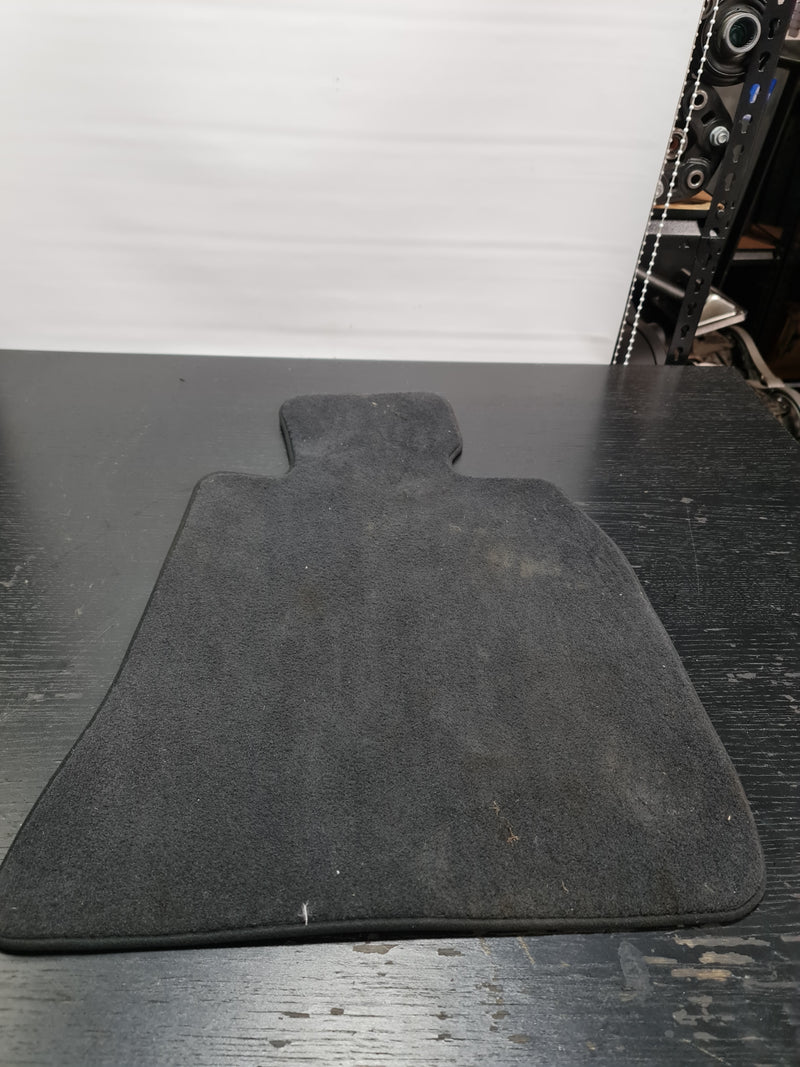 G80 M3 drivers floor mat by MPerformance.parts showing durable black rubber surface with logo detail, designed for vehicle protection.