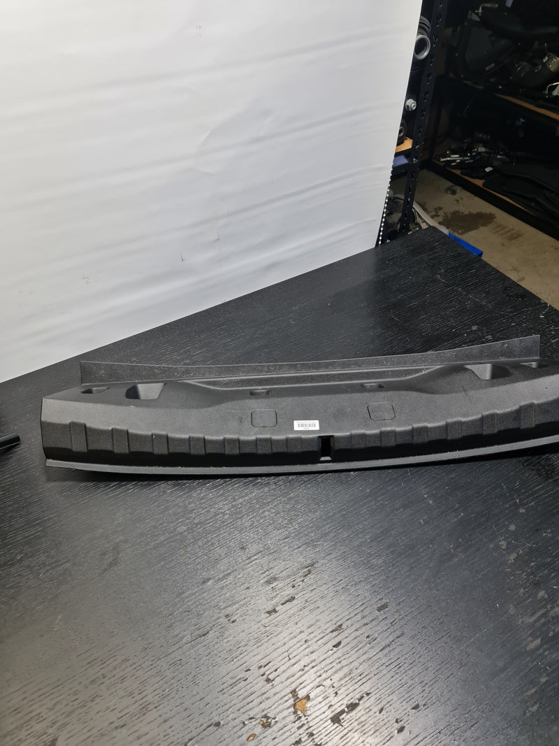 OEM BMW G20 330 M340 rear trunk boot lid latch lock sill scuff plate cover by MPerformance.parts, showing the black trim cover.