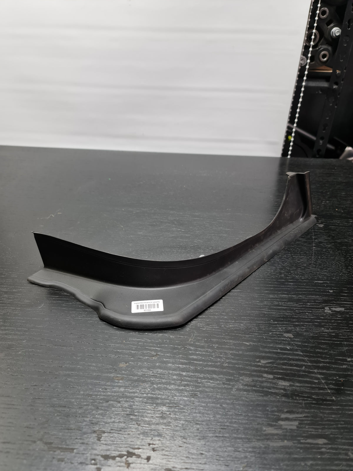 BMW 330i G20 right side water channel cover trim panel in black OEM trunk part by MPerformance.parts, visible in the image.