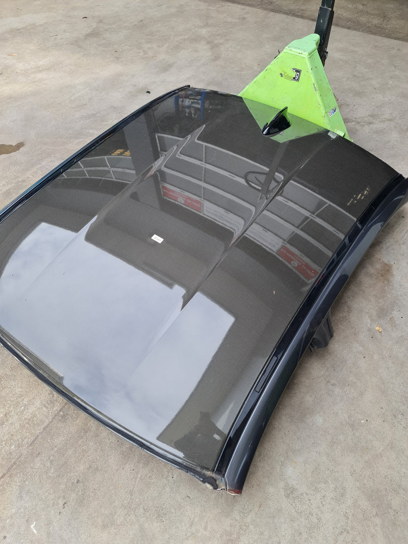 F80 M3 carbon fiber roof outer panel with PPF coating, featuring sleek black carbon fiber surface and detailed texture.