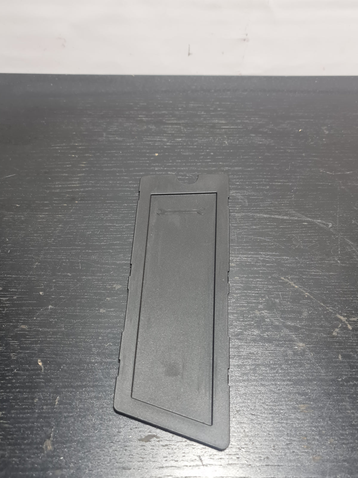 BMW G80 M3 trunk left storage compartment tray by MPerformance.parts, showing the black molded plastic interior with compartment details.