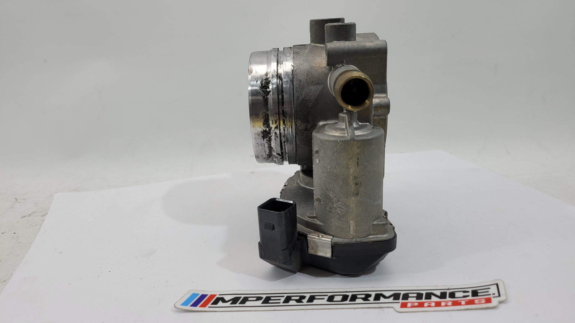 BMW M3 M4 F80 F82 F83 S55 engine throttle body by MPerformance.parts, showing the metal component with connector ports.