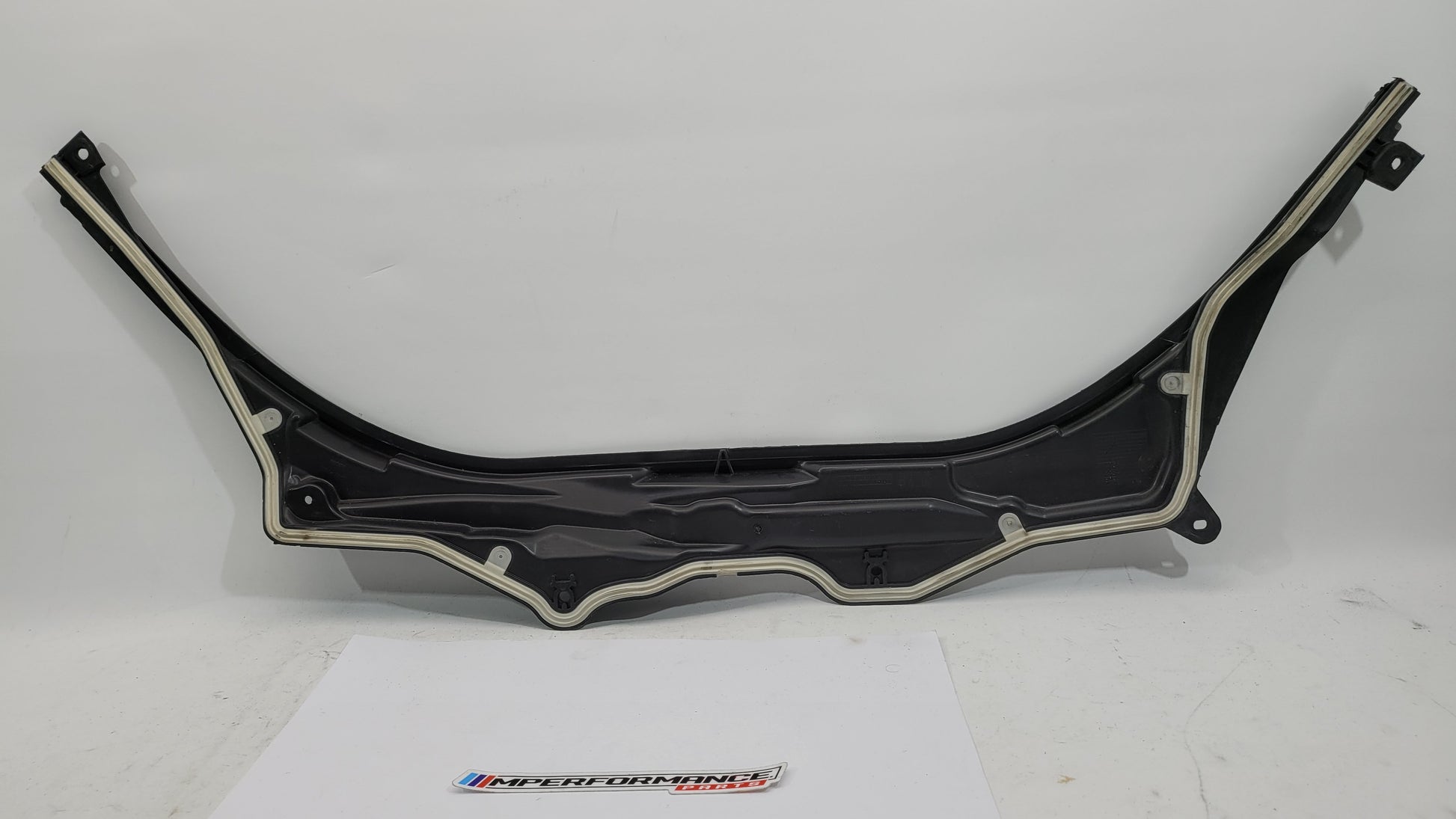 BMW M3 Series G8x upper firewall cover panel by MPerformance.parts, showing the sleek black metal design with mounting points.
