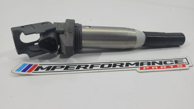 BMW F3x F8x petrol ignition coil by MPerformance.parts, showing a close-up of the black coil with connectors and mounting points.