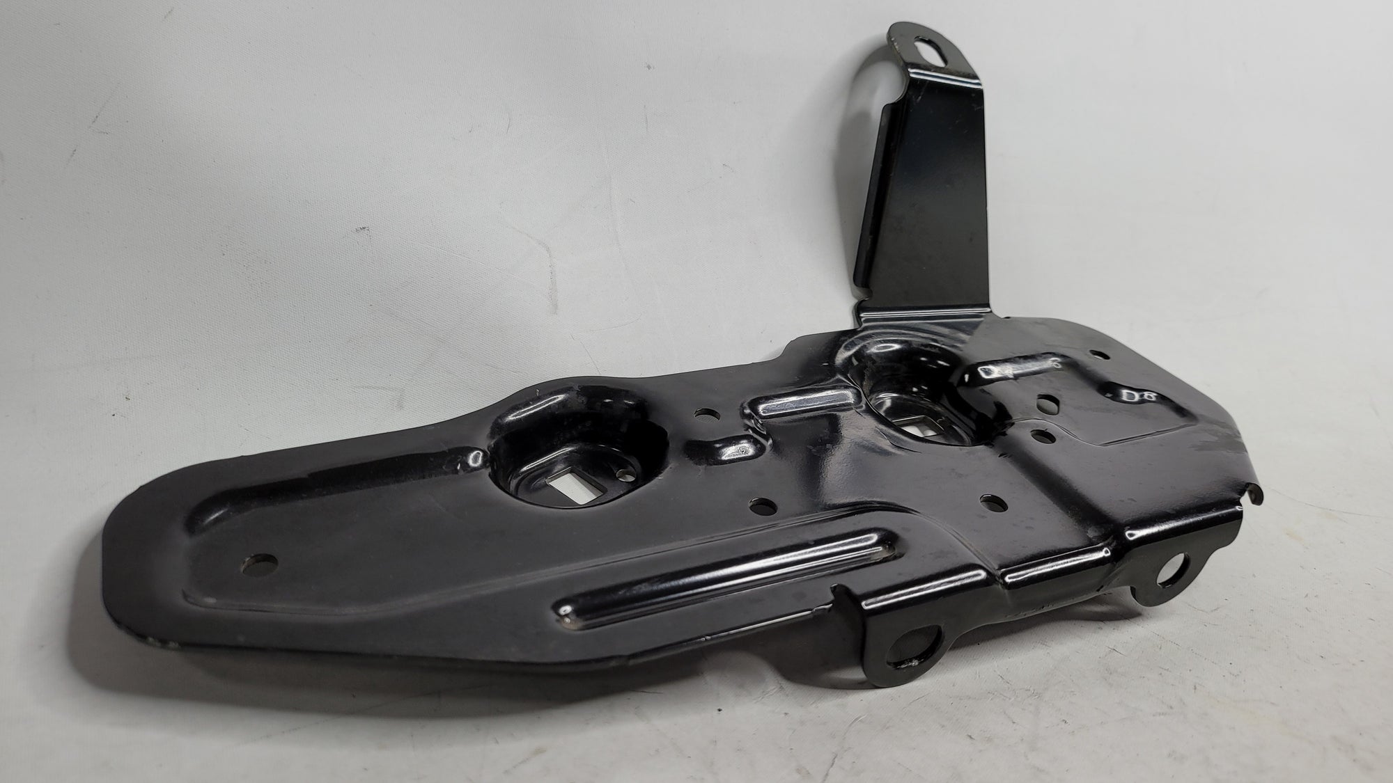 BMW 328I F30 underbody fuel tank guard plate and fuel line bracket, black metal mount for engine protection and fuel line support.