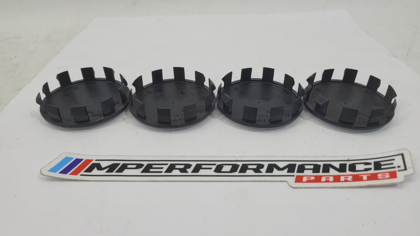 Set of four BMW 50th Anniversary G80 wheel caps featuring MPerformance.parts branding and detailed design for G80 series wheels.