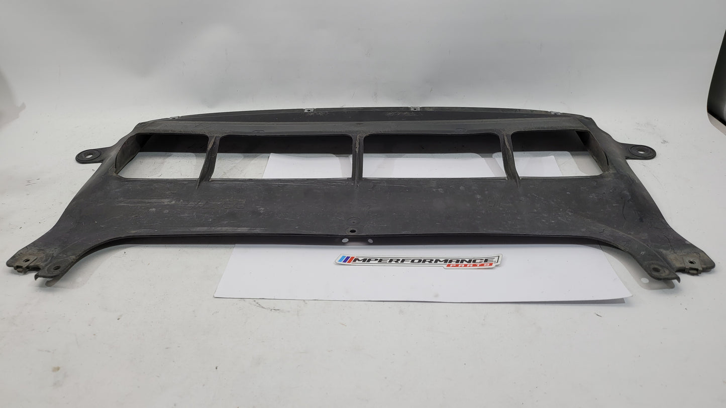 BMW M3 F80 front centre bumper belly pan by MPerformance.parts, showing the black plastic aerodynamic component with mounting points.