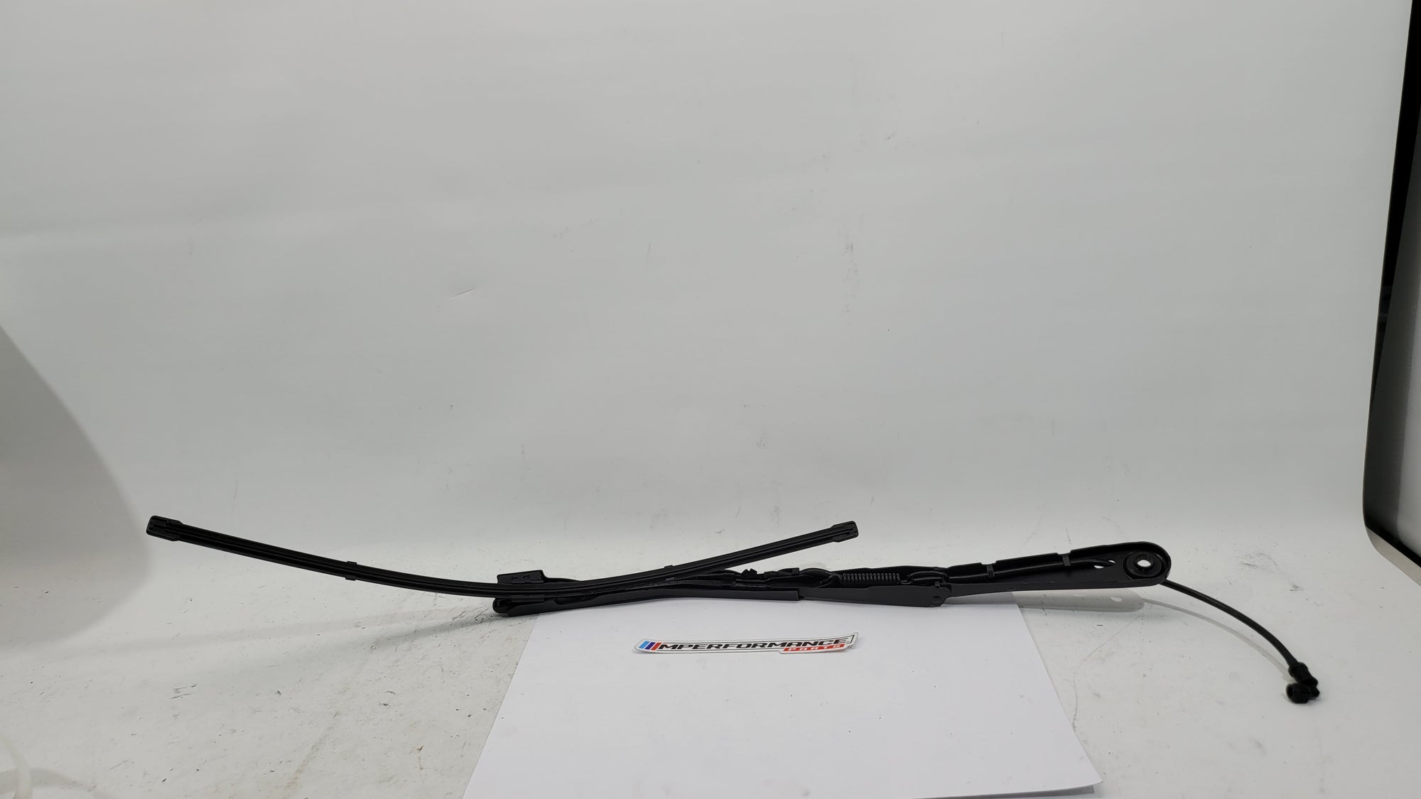 BMW M3 G8x driver side front wiper arm by MPerformance.parts, showing the sleek metal wiper arm with mounting connection.