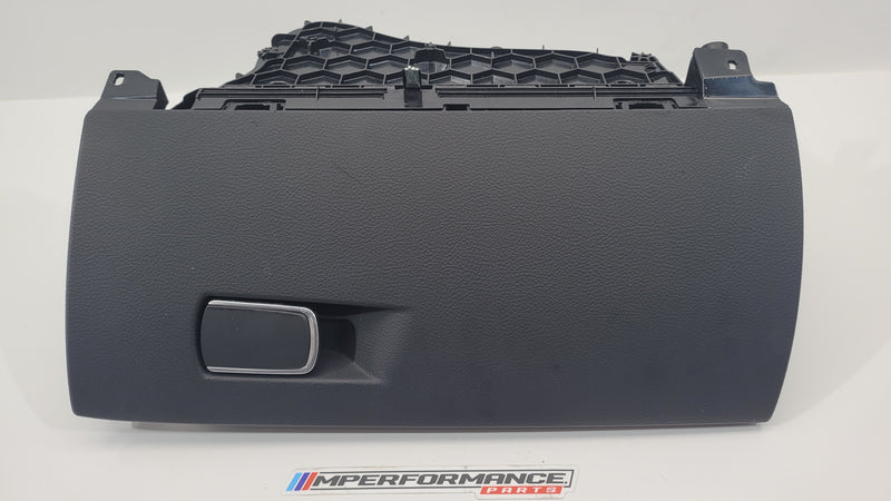 BMW M2 F87 COMP glove box part by MPerformance.parts, showing the black glove box interior with textured finish.