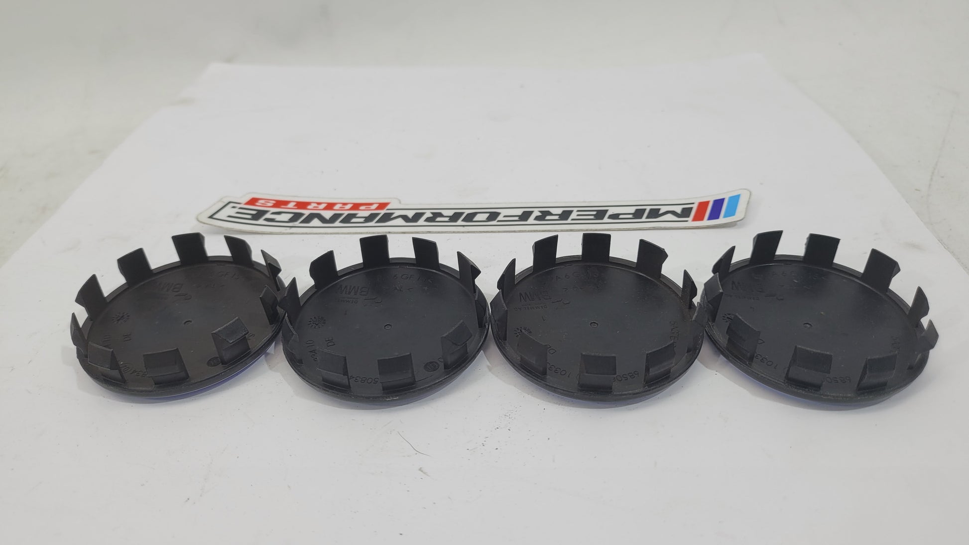 BMW 50th Anniversary G80 wheel cap set of 4 by MPerformance.parts, close-up of shiny silver caps with BMW logo for G80 model wheels