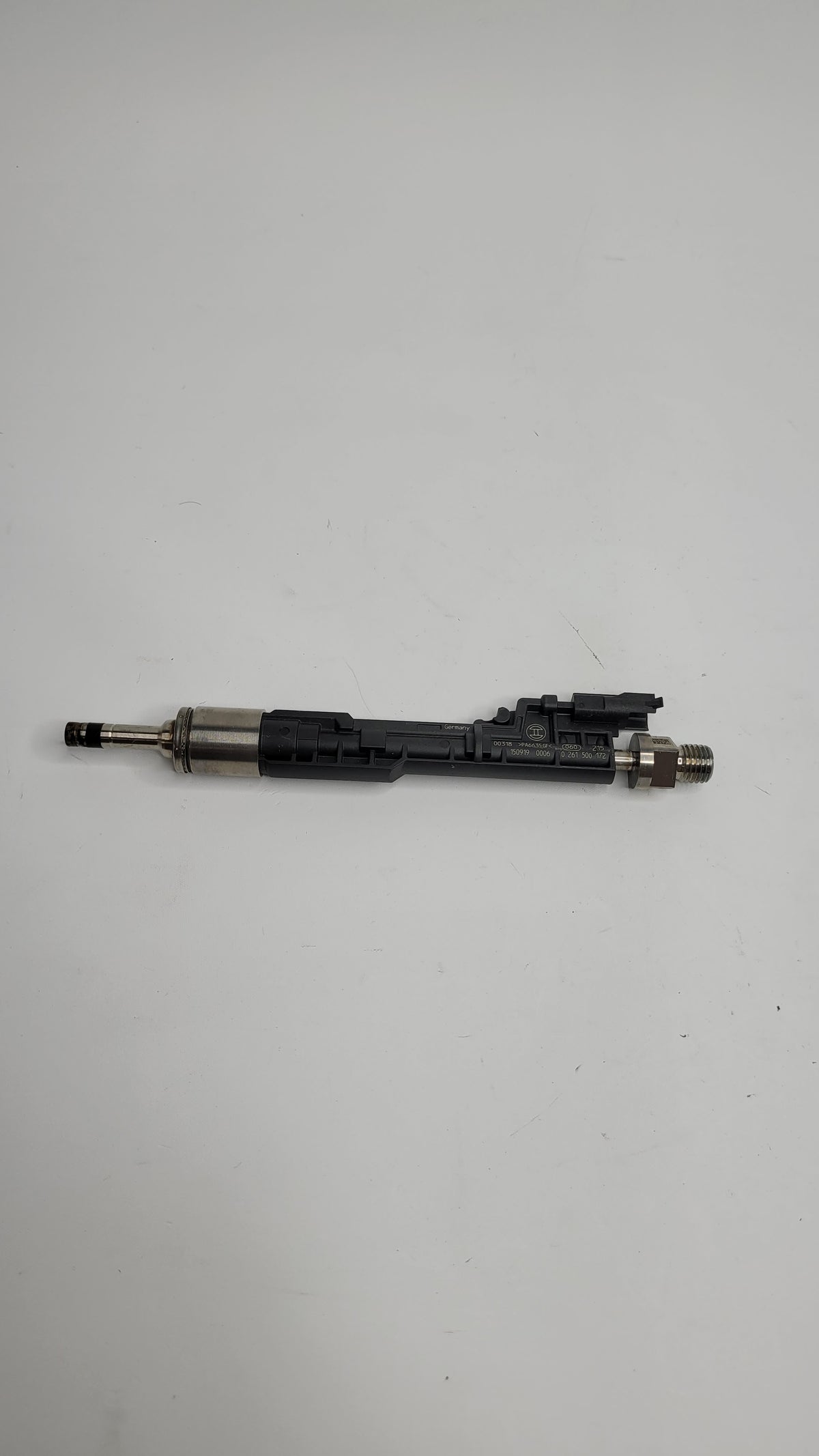MPerformance.parts F80 M3 injector showing metal body and nozzle for high-performance fuel delivery.