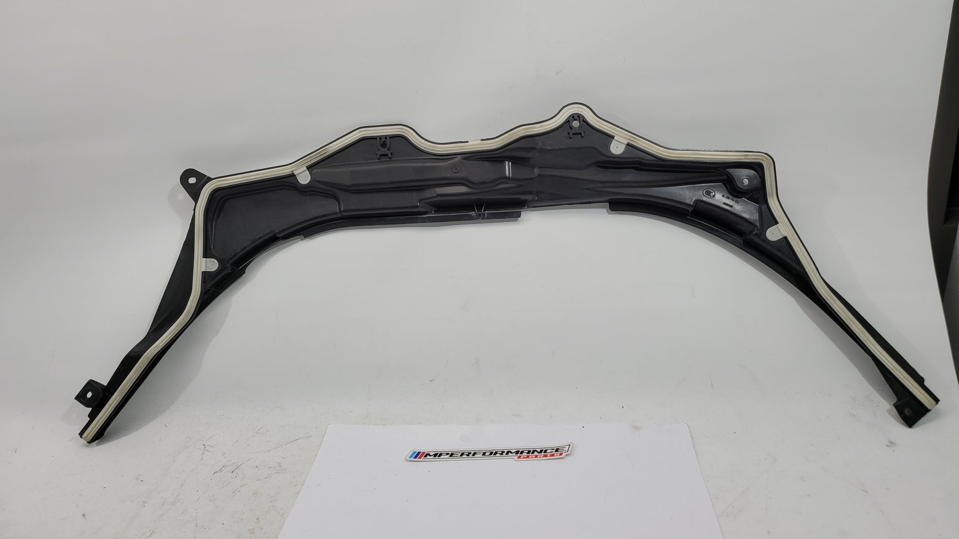 BMW M3 G8X firewall upper section cover panel in black, with mounting points and textured finish, designed for engine bay protection.