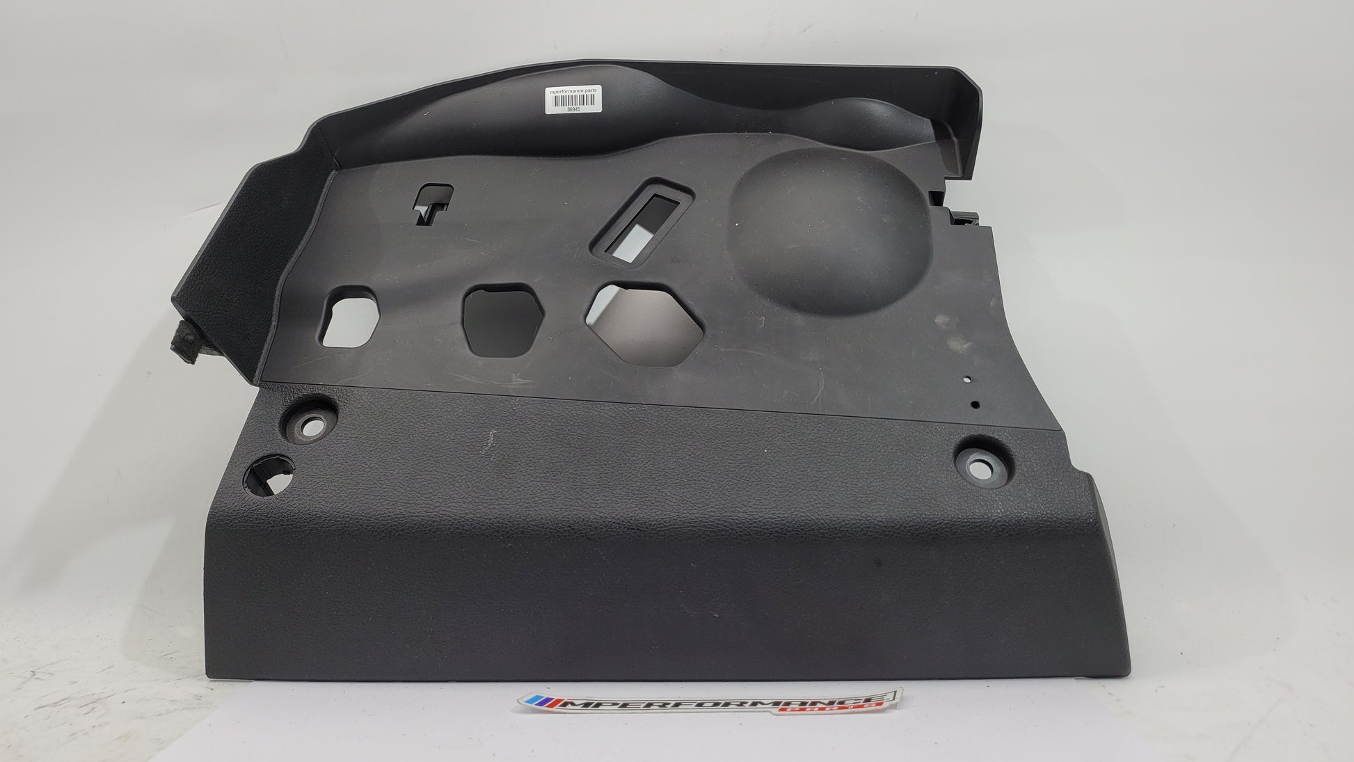 BMW 1 Series F20 F21 F23 front left lower dash cover panel trim by MPerformance.parts, showing the textured interior dashboard component.