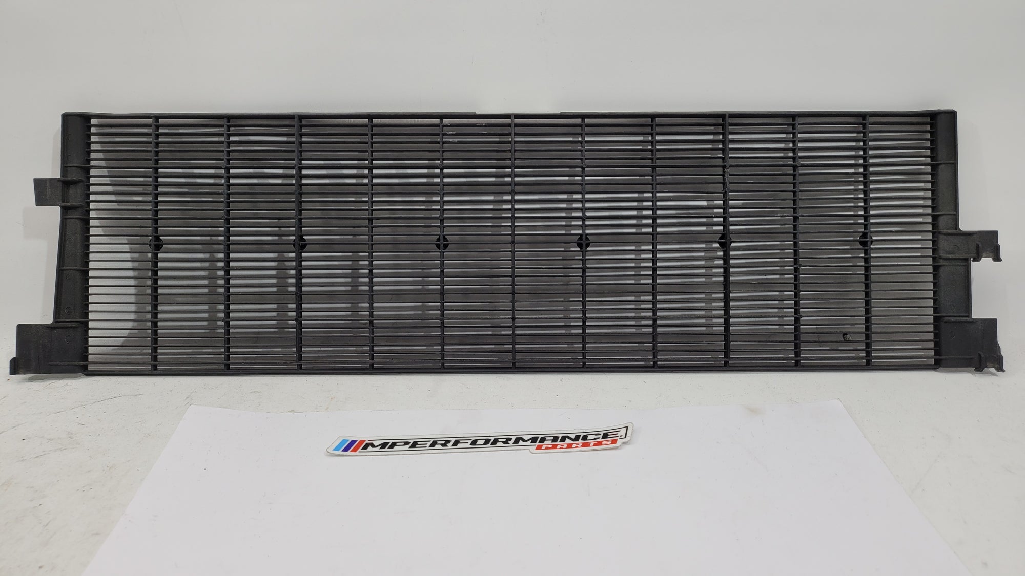 BMW G80 G82 G83 M3 M4 Competition plastic radiator cover shroud by MPerformance.parts, showing the sleek black engine cover component.