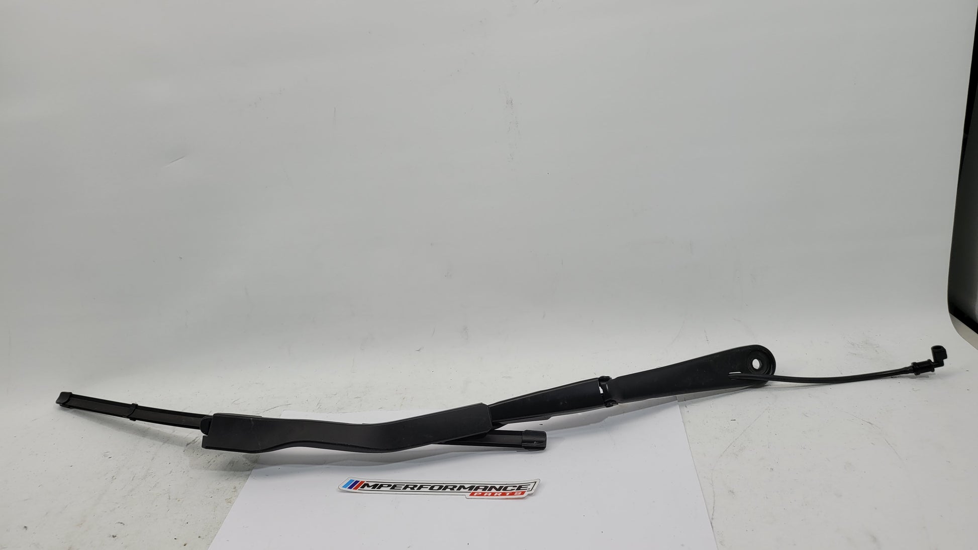 BMW M3 G8x driver side front wiper arm in black metal with mounting hardware, designed for BMW MPerformance.parts vehicle.