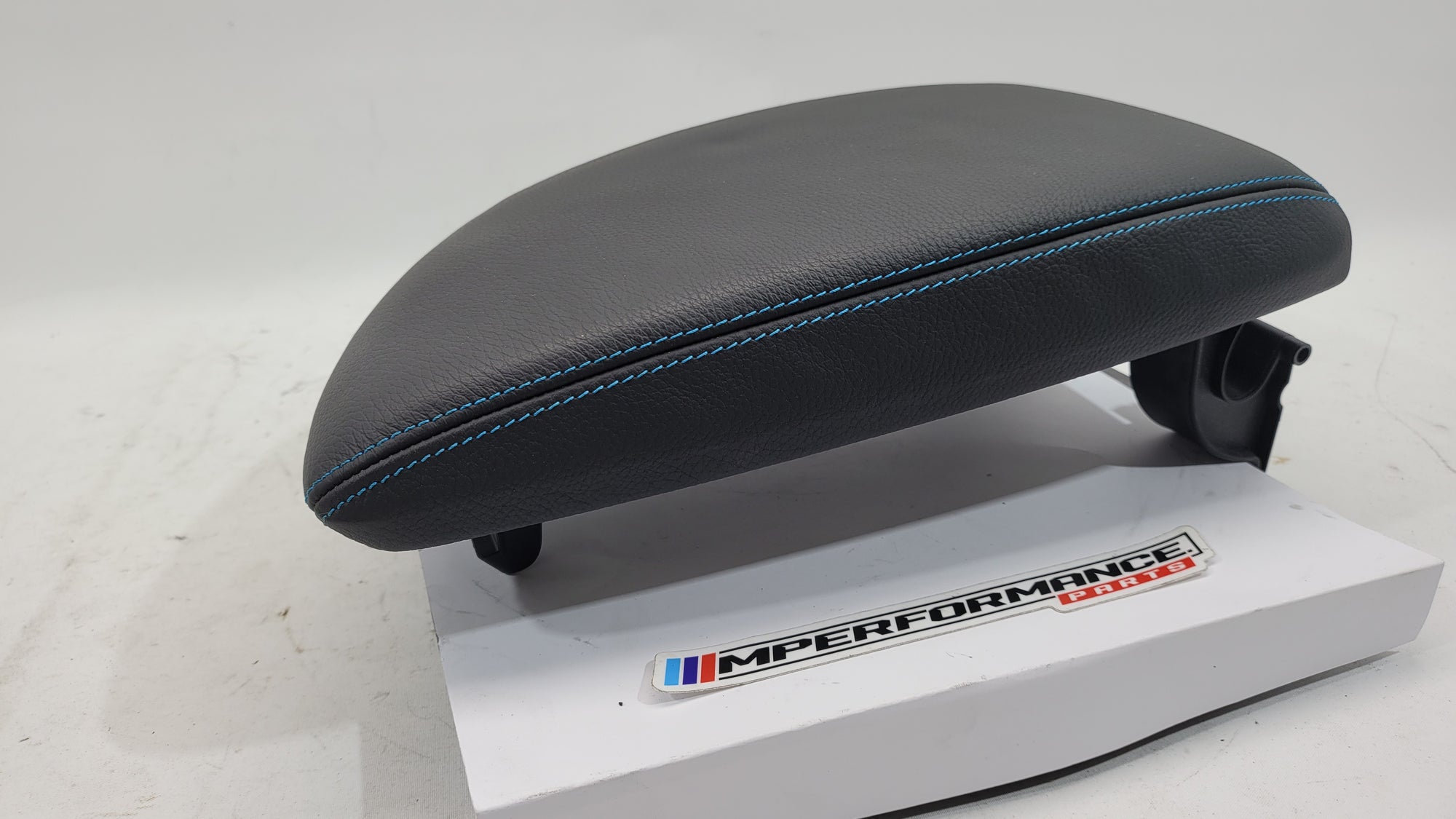 BMW M2 F87 Competition leather armrest with blue stitching, showing the sleek leather surface and detailed stitching design.