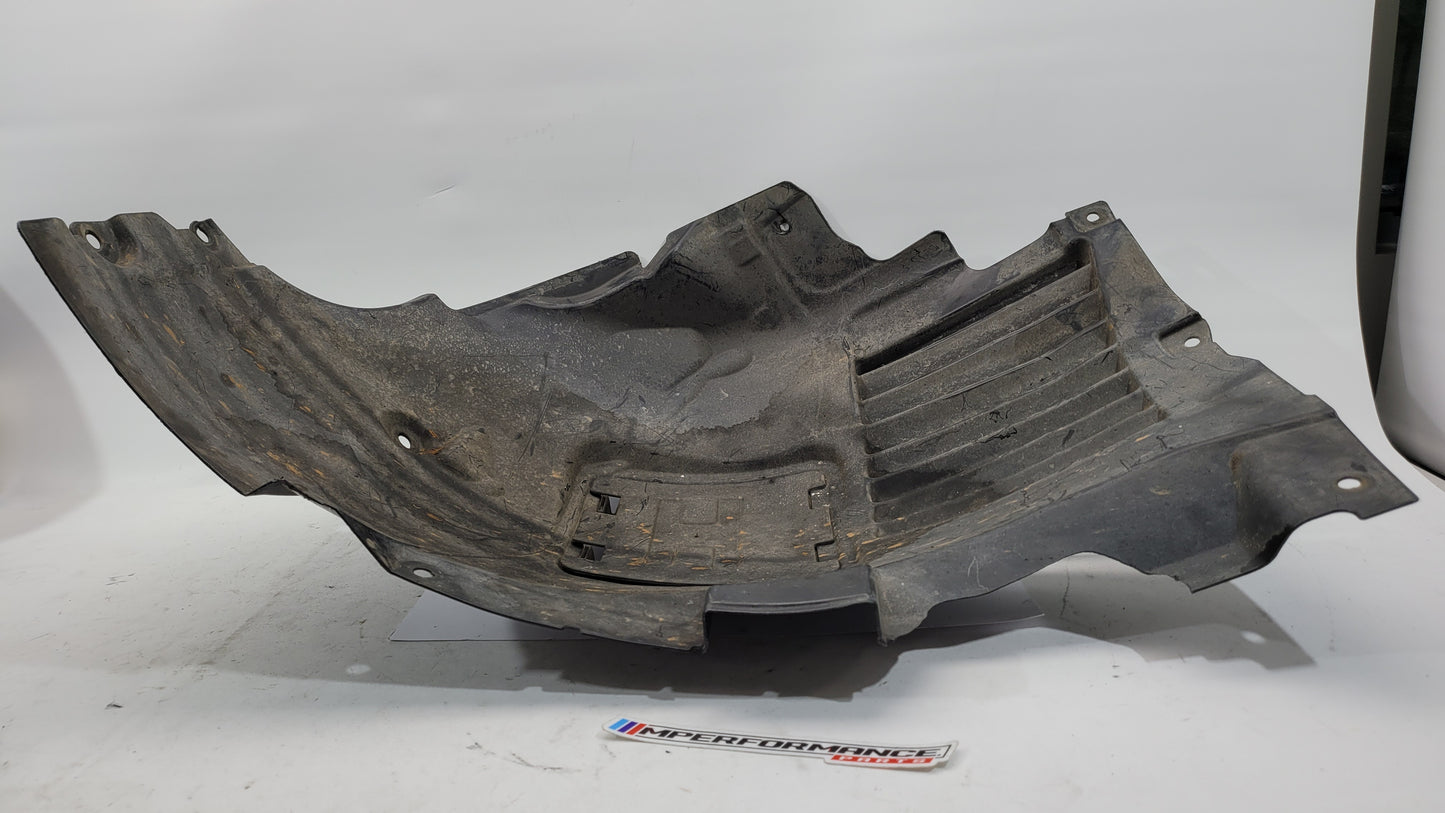 BMW F80 M3 F82 F83 M4 front inner fender liner left in black, showing detailed plastic construction and mounting points.