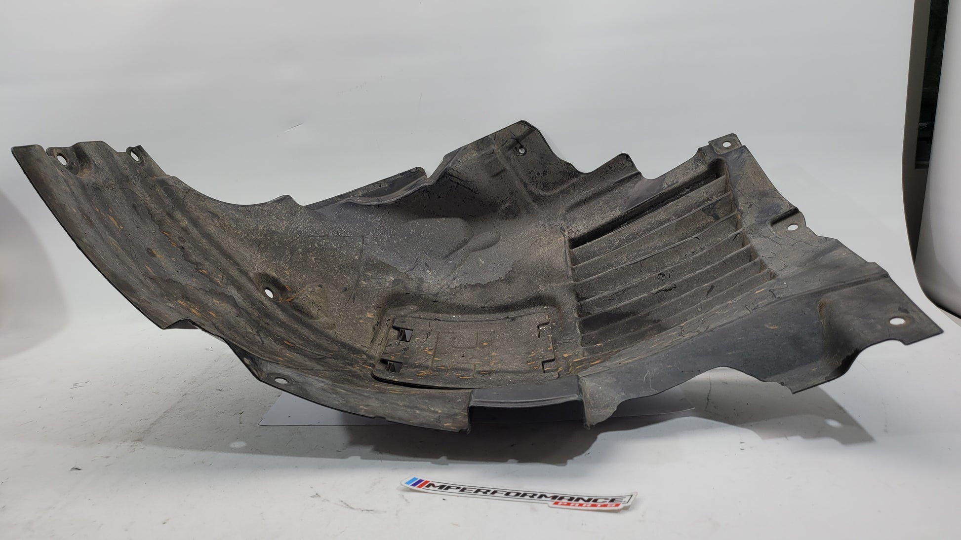 BMW F80 M3 F82 F83 M4 front inner fender liner left in black, showing detailed plastic construction and mounting points.