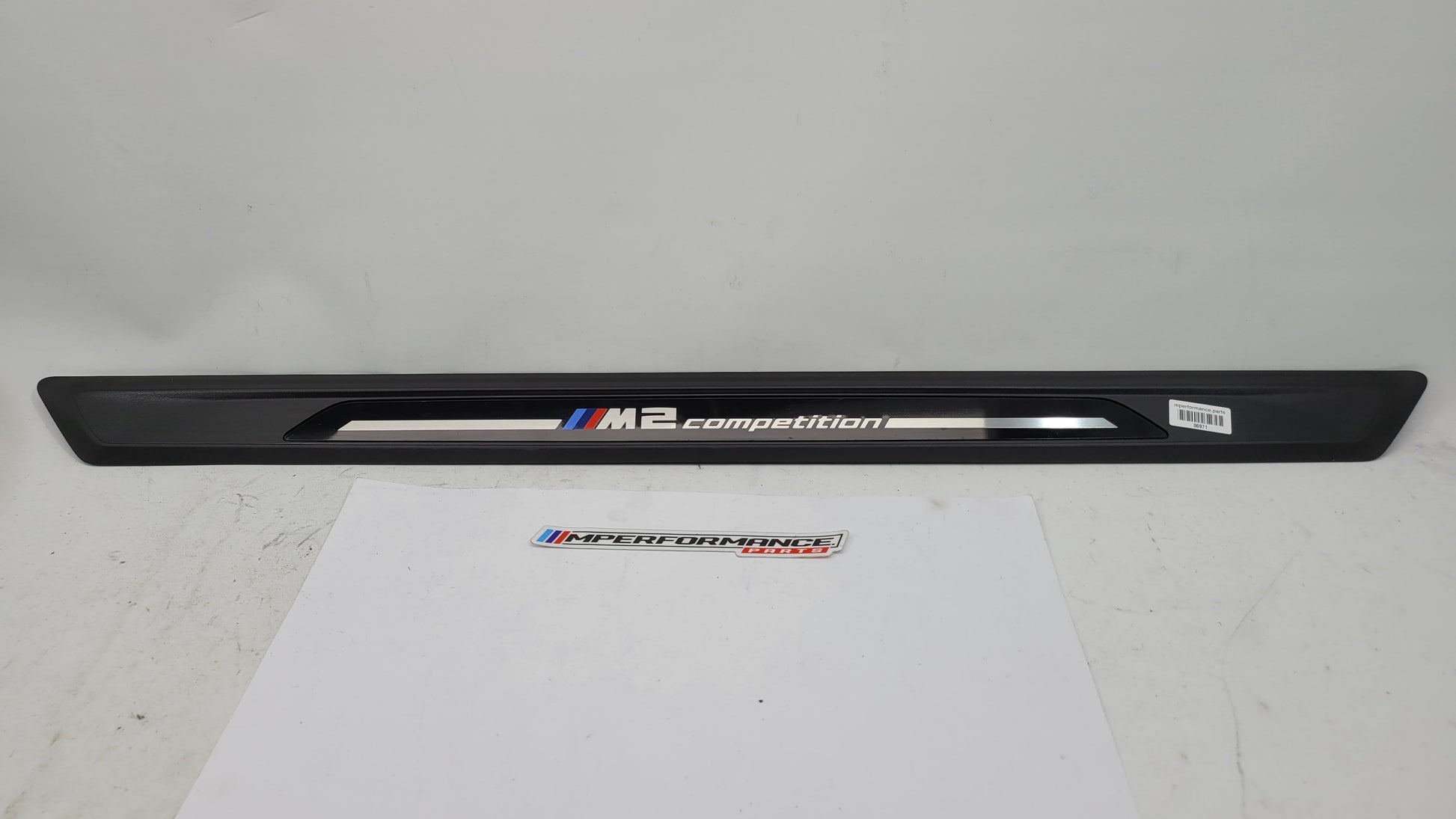 BMW M2 Competition F87 door sill scuff plate, left or right, black with MPerformance.parts branding, installed on vehicle.