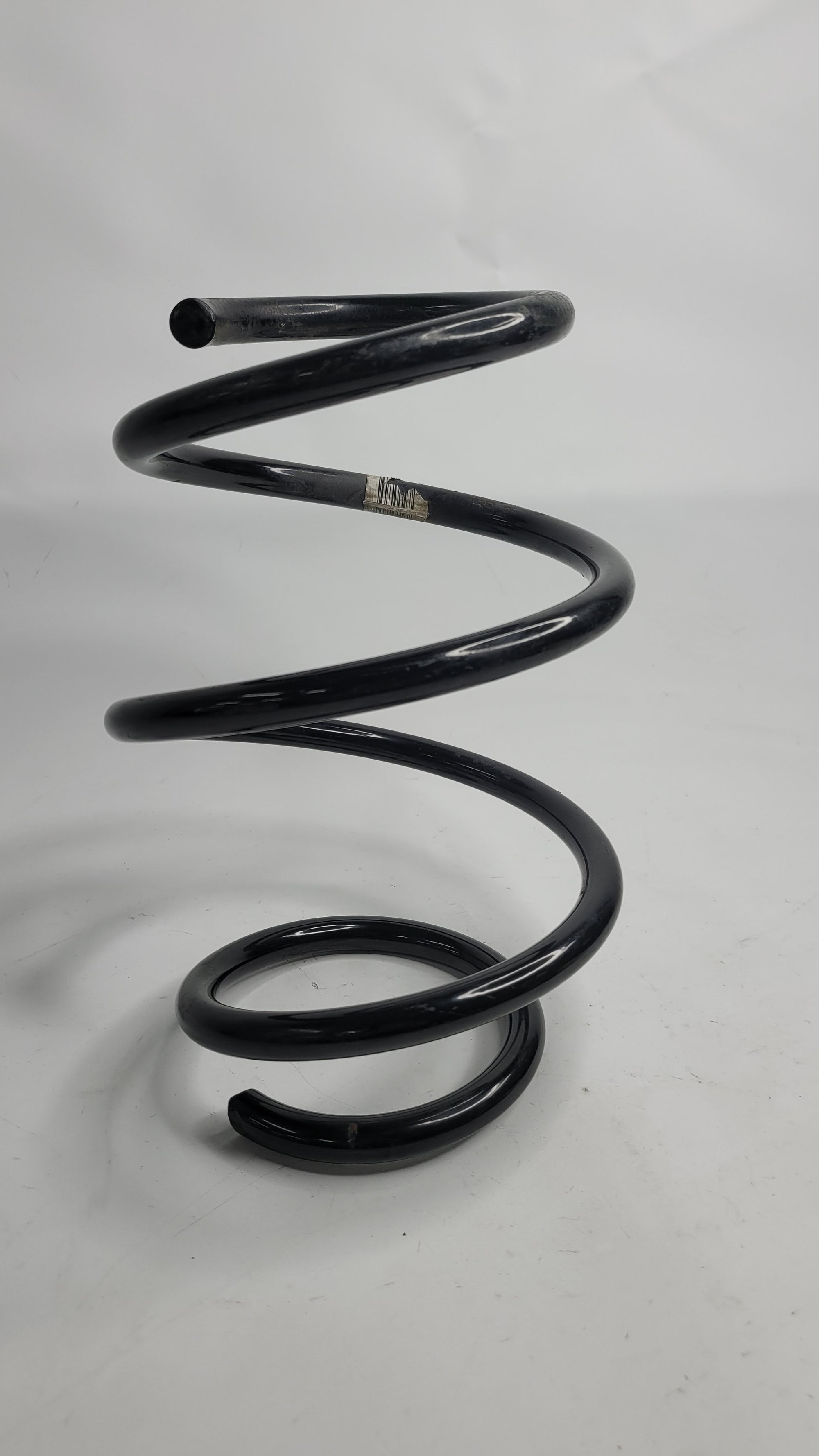 BMW F8X M2/3/4 front spring from MPerformance.parts, showing a close-up of the black coil spring with mounting ends.