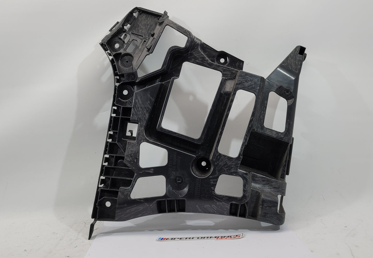 BMW M3 M4 G80 G82 rear left bumper corner bracket by MPerformance.parts, showcasing the sturdy automotive component.