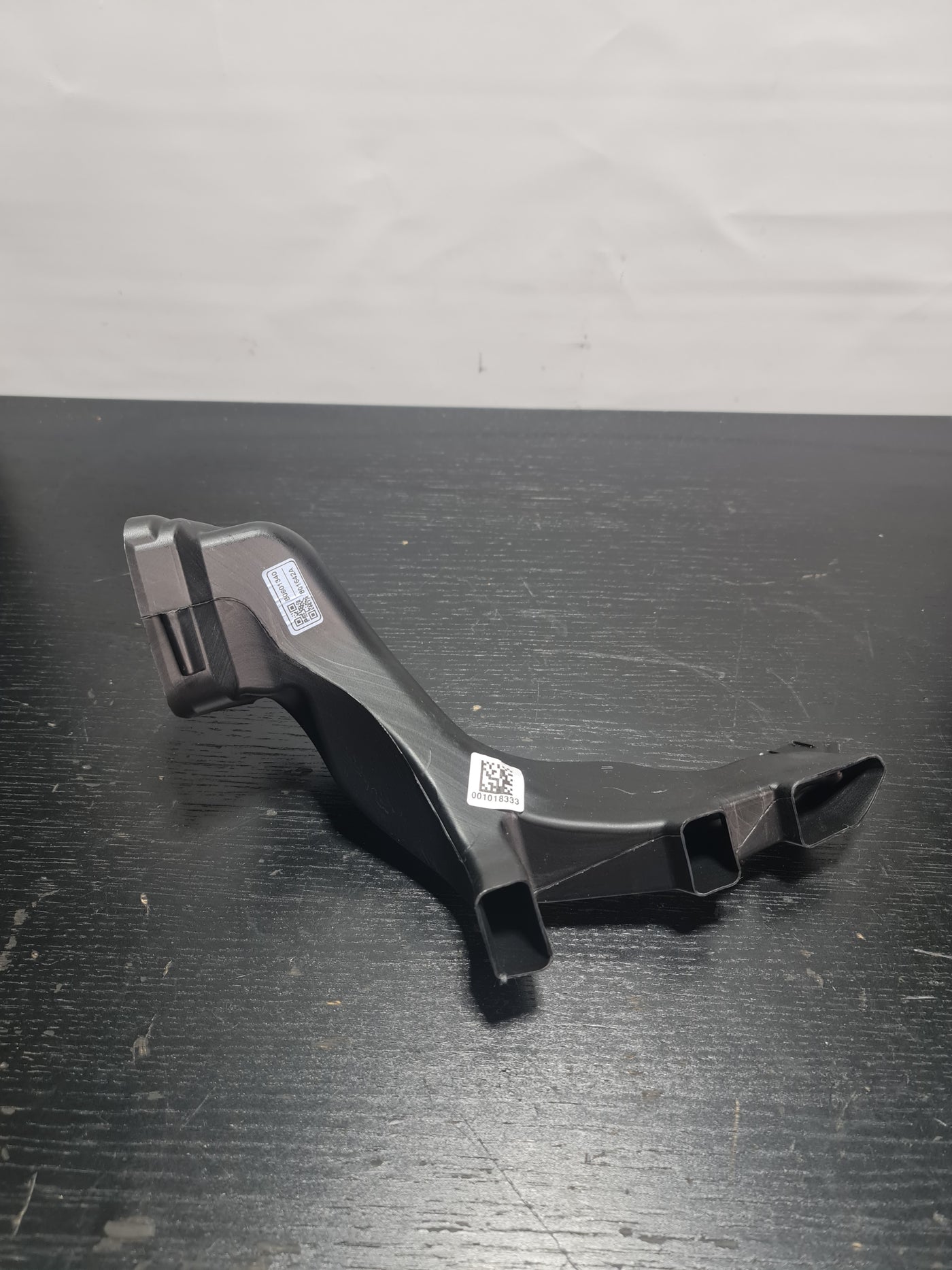 BMW 3 G80 MPerformance.parts air intake tube, black plastic with metal clamps, designed for engine airflow enhancement.