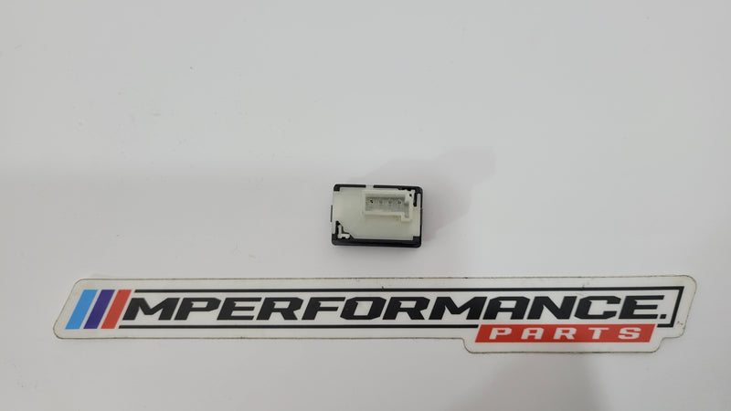 BMW F8X G8X M3 boot release button switch, MPerformance.parts, close-up of the black plastic switch for trunk release.
