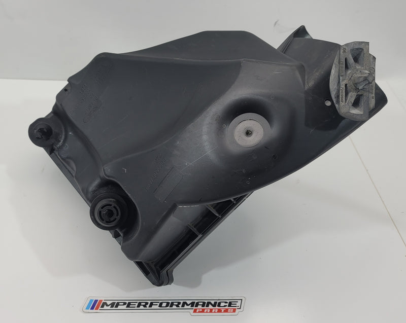 BMW M3 Competition G80 air filter box by MPerformance.parts, showing the black plastic housing and air intake components.