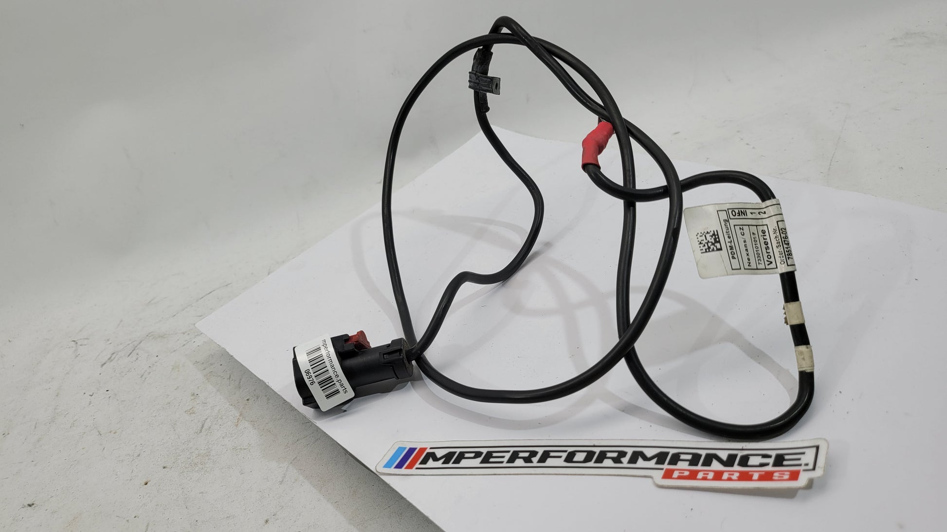 BMW F83 M4 positive battery power distribution cable by MPerformance.parts, showing the black cable with connectors on each end.
