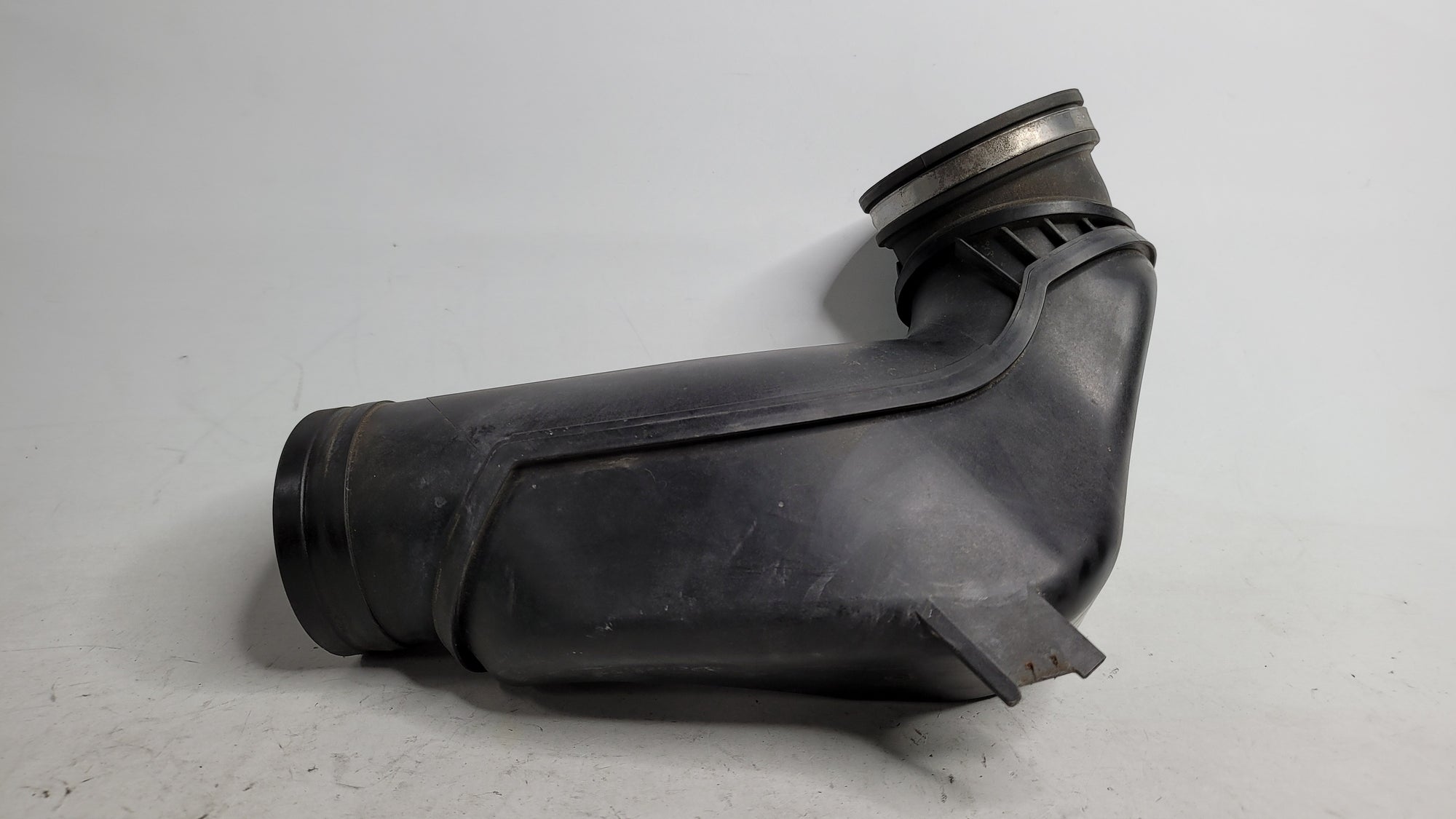 BMW 328i 320i F30 air cleaner intake tube duct hose made of plastic by MPerformance.parts, shown in the image.