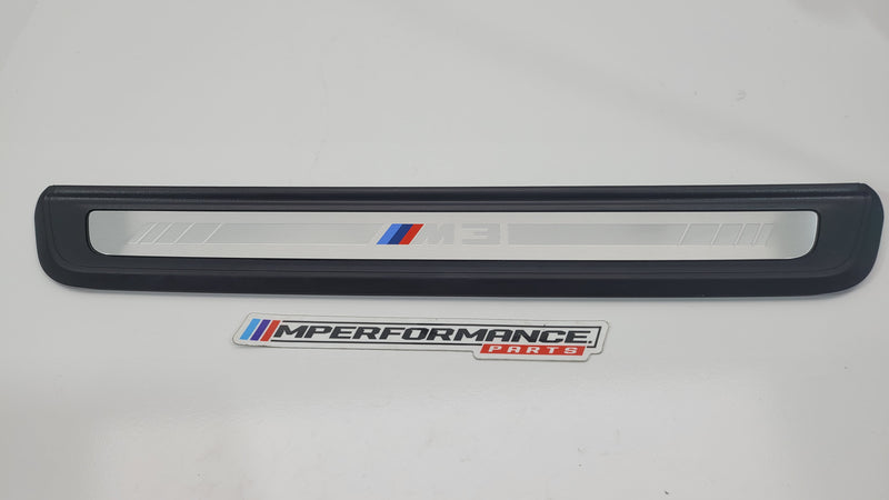 BMW M3 G80 door sill scuff plate with black finish, engraved MPerformance.parts branding, installed on vehicle door sill area.