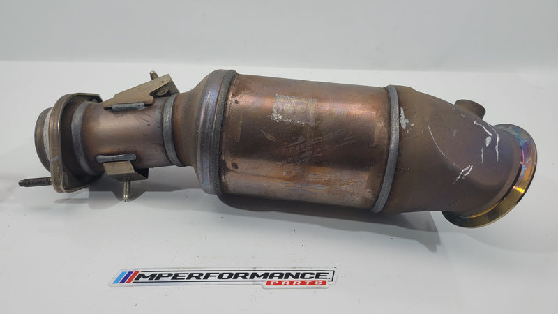 BMW M4 G82 Competition turbo to midpipe catalytic converter by MPerformance.parts, showing the metal component with mounting points.