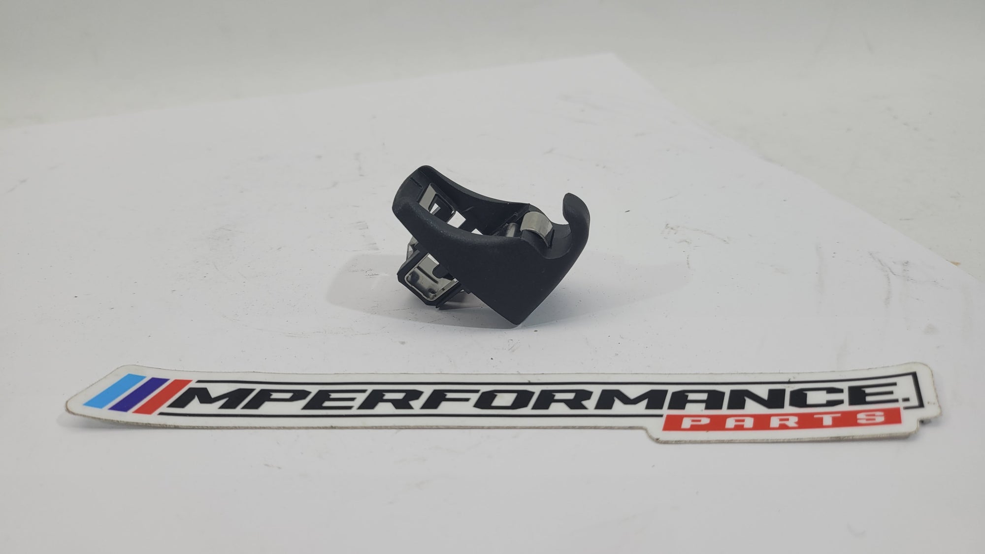 BMW sun visor screen clip 7277251 by MPerformance.parts, showing the small black plastic clip on a plain background.