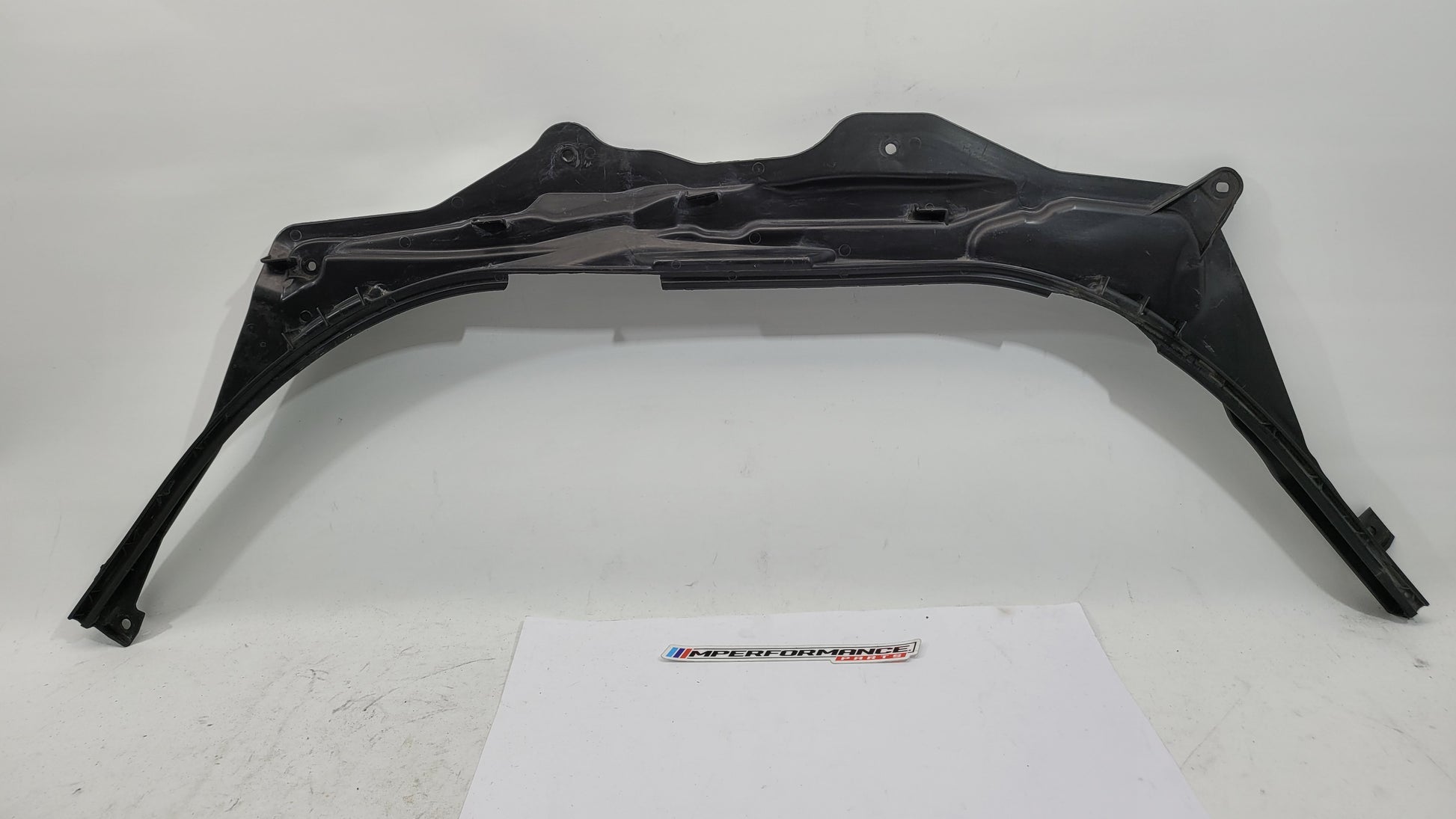 BMW M3 G8X firewall upper section cover panel by MPerformance.parts, showing the black protective metal cover with mounting points
