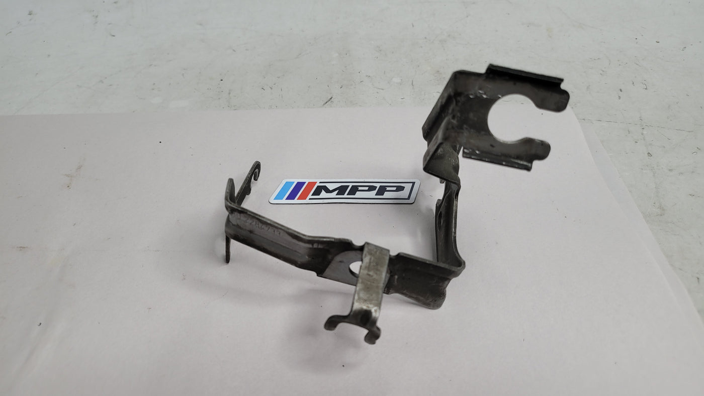 BMW 4 Coupe F32 F82 front left wheel hose holder by MPerformance.parts, showing the black plastic component mounted on the wheel well