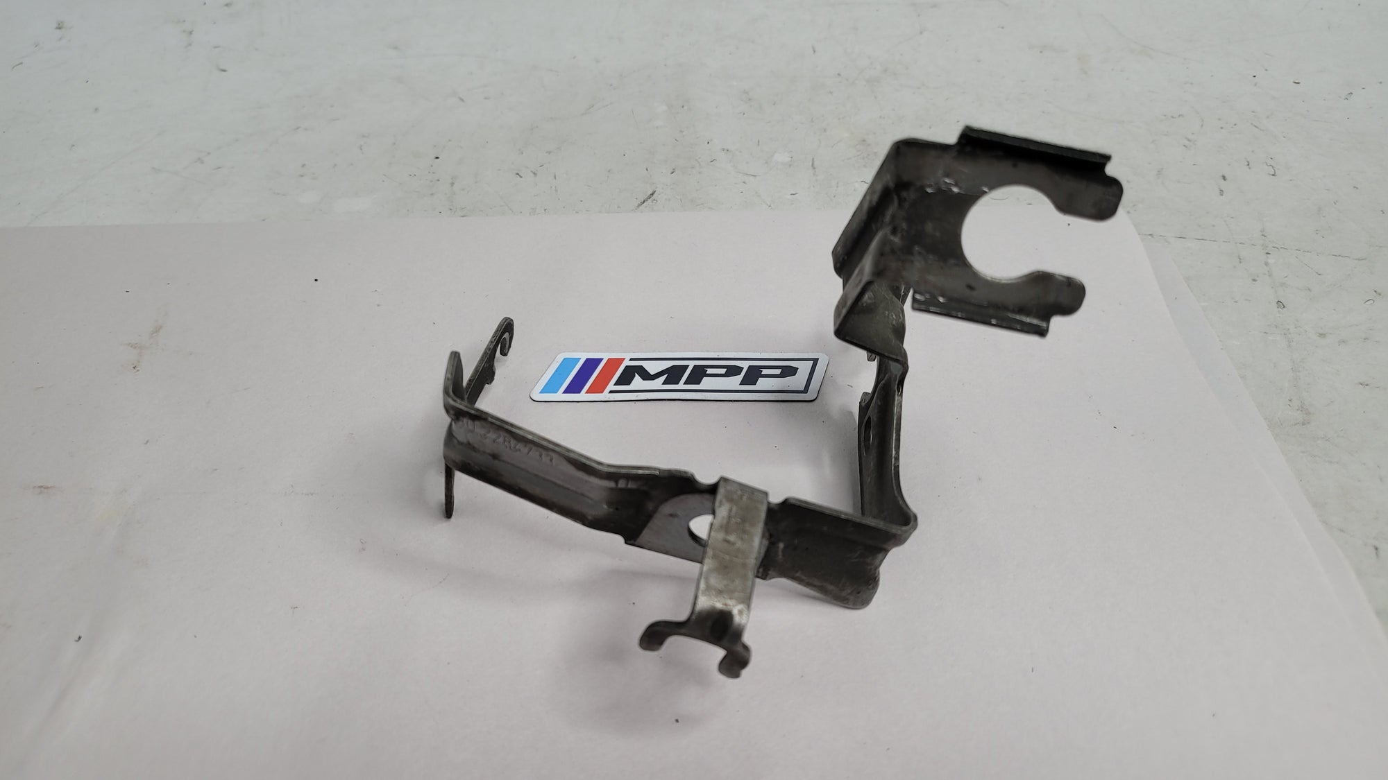 BMW 4 Coupe F32 F82 front left wheel hose holder by MPerformance.parts, showing the black plastic component mounted on the wheel well