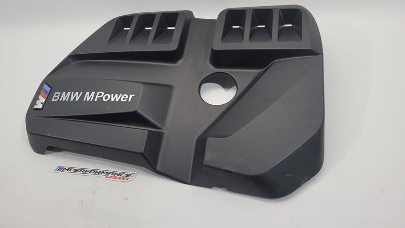 BMW 3 Series M3 Competition G80 engine cover with MPerformance.parts branding, featuring a sleek black design and detailed engine branding.