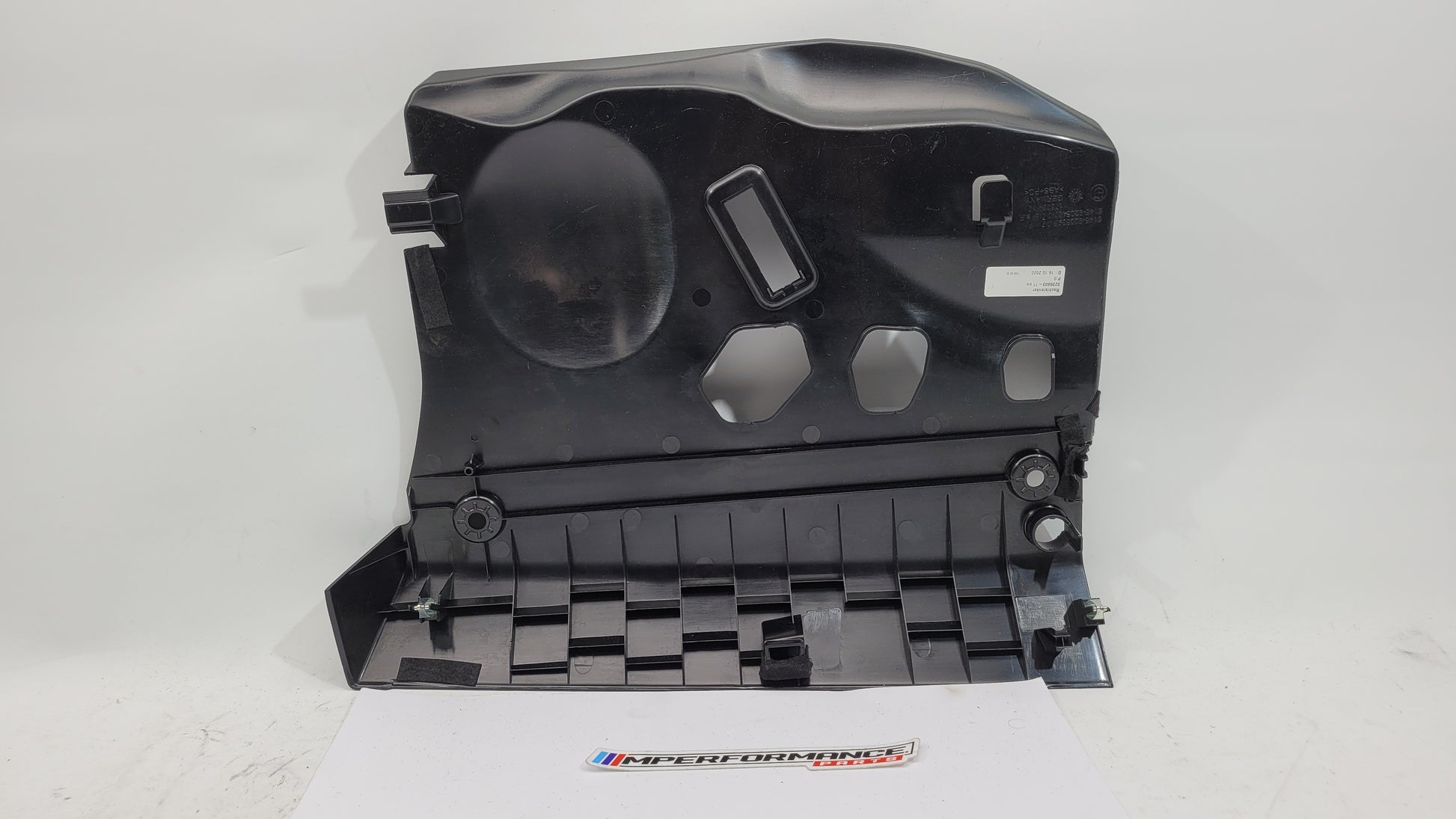 BMW 1 Series F20 F21 F23 front left lower dash cover panel trim in black with MPerformance.parts branding visible.