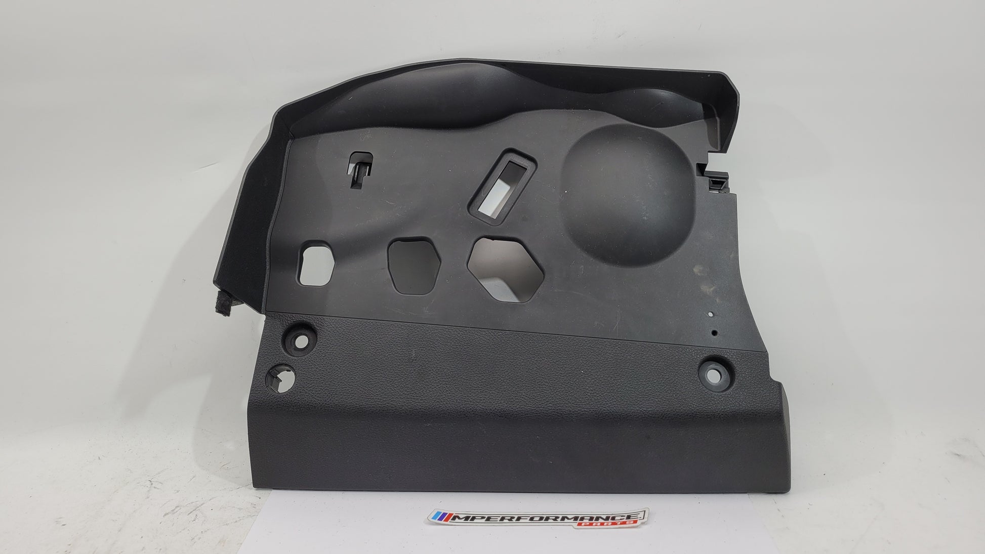 BMW 1 Series F20 F21 F23 front left lower dash cover panel trim by MPerformance.parts, showing the black plastic trim piece.