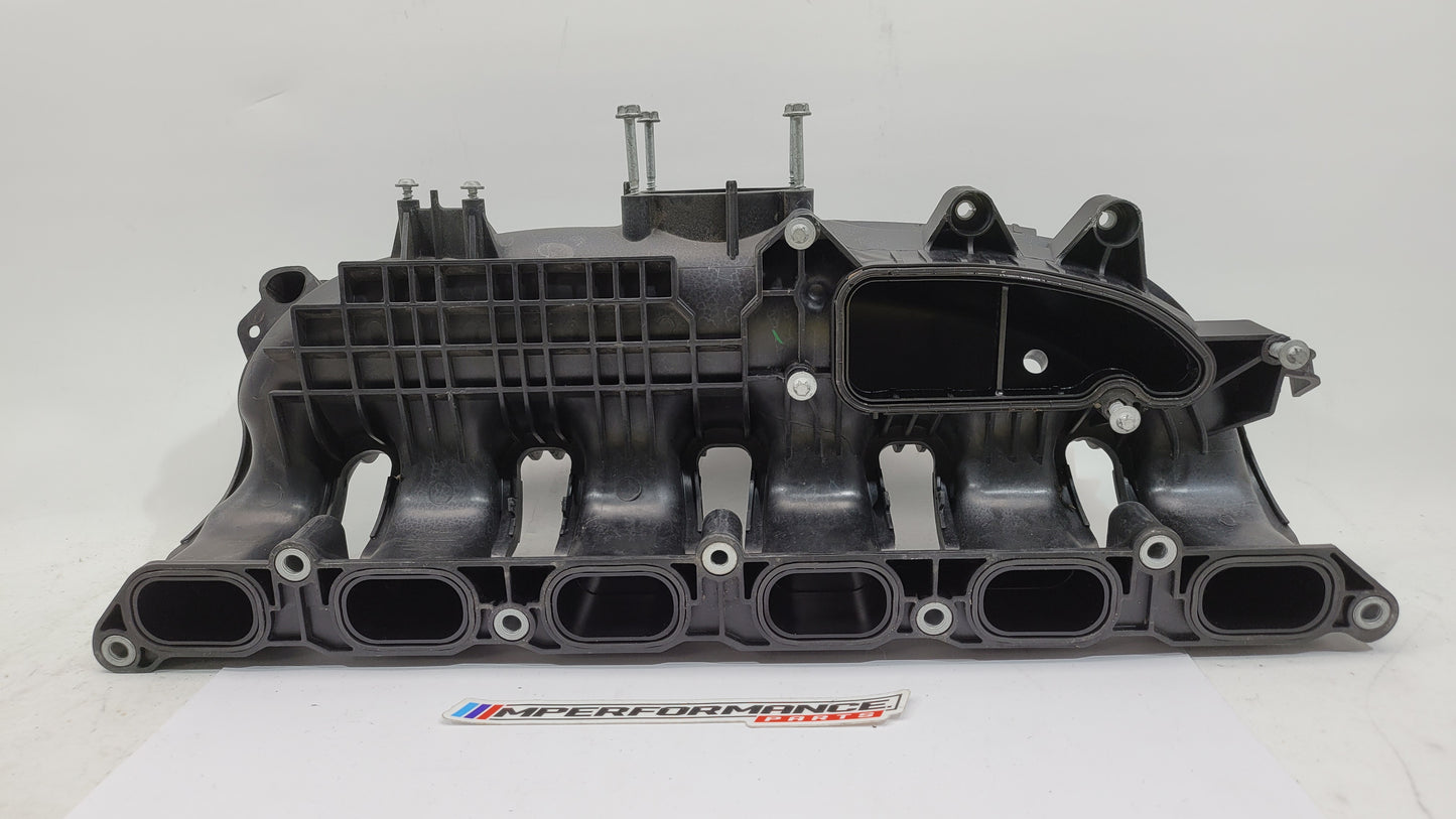 BMW N55 S55 3.0L engine intake manifold from MPerformance.parts, showing the black plastic component with mounting points and openings.
