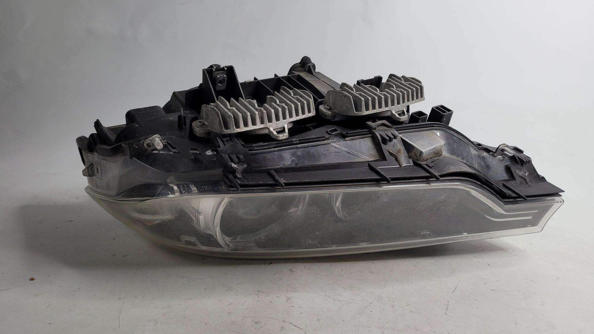 BMW 3 Series 2013-2019 passenger side xenon headlight headlamp in black for left side, part number 7259543.