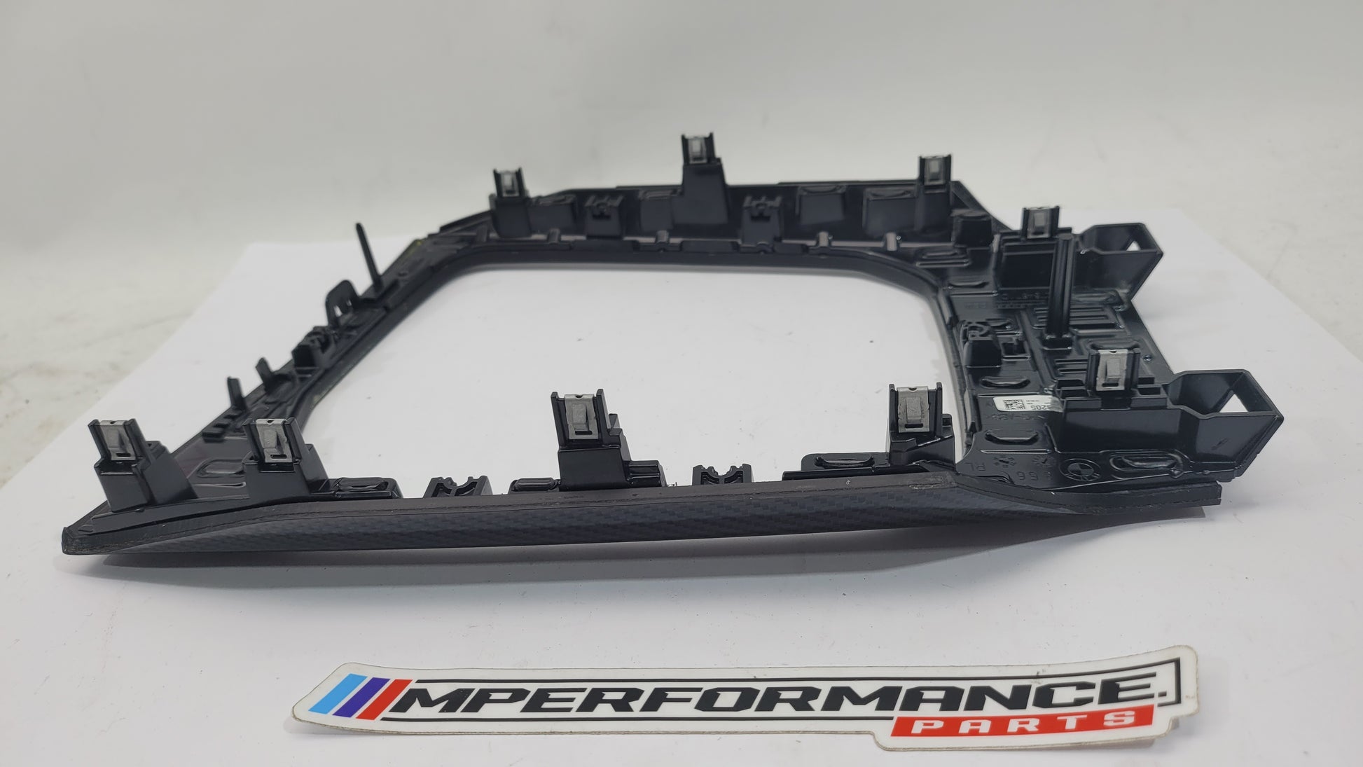 BMW M3 G80 interior carbon trim from MPerformance.parts, featuring sleek black carbon fiber accents on dashboard and door panels.