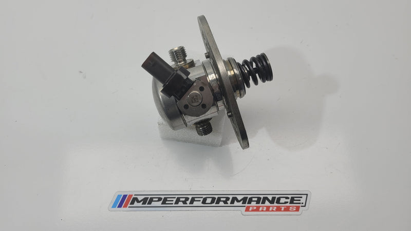 High pressure pump S58 G8x by MPerformance.parts, showing the metal pump with inlet and outlet ports for BMW engine.