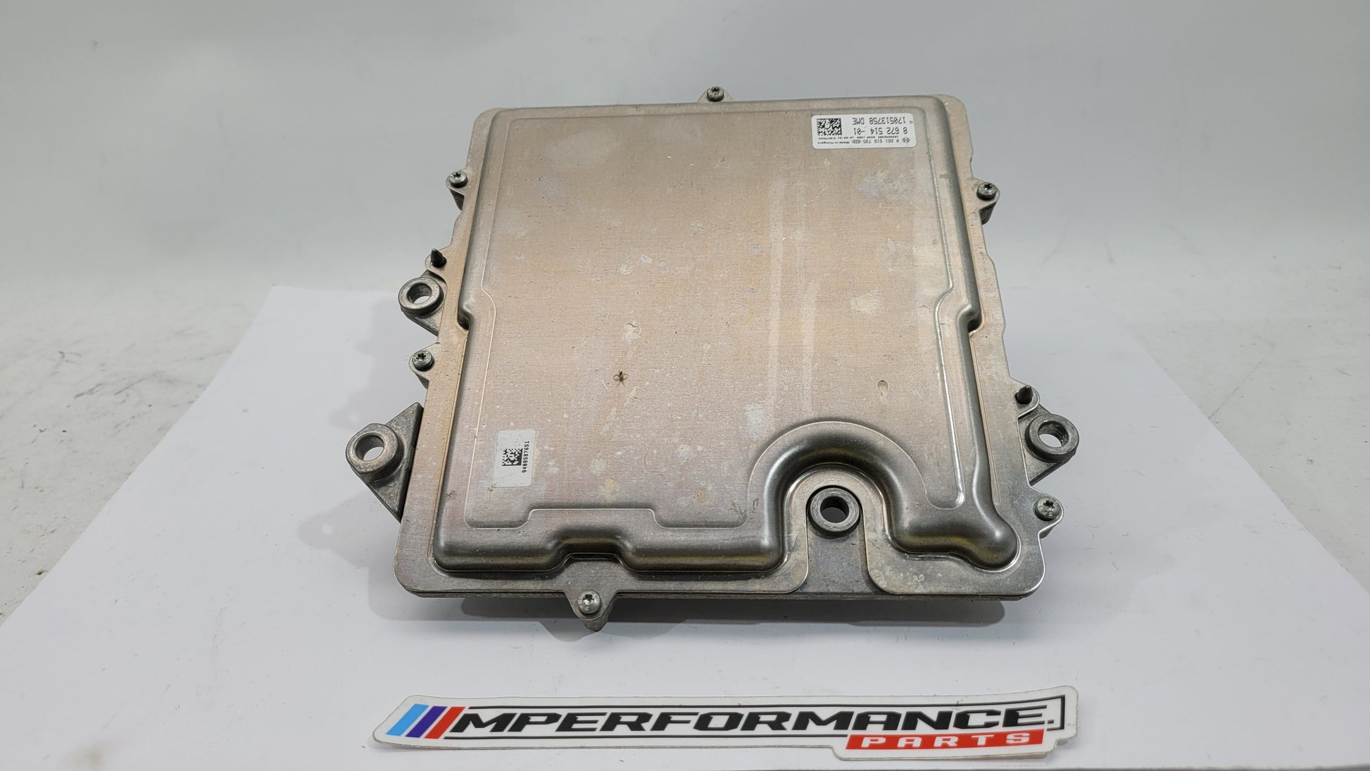 BMW M4 F82 3.0 petrol engine control module by MPerformance.parts, showing the black electronic component with connectors.