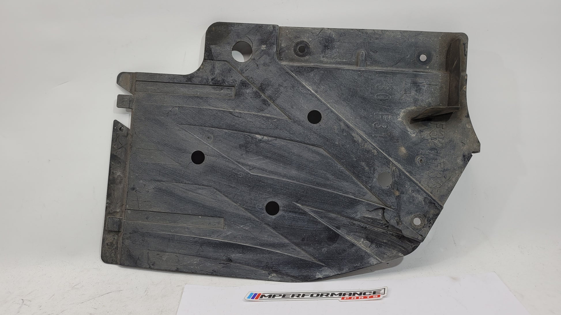 BMW M3 M4 series rear left underbody panel by MPerformance.parts, showing the black undercarriage component for F80, F82, and F83 models.