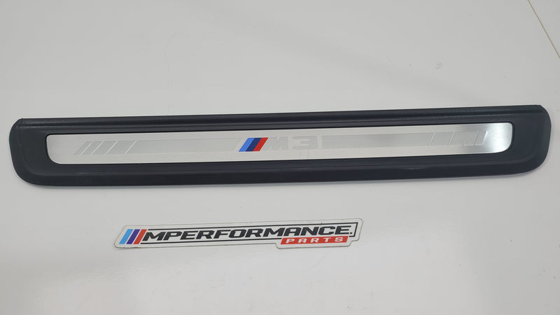 BMW M3 G80 door sill scuff plate in black with MPerformance.parts branding, installed on car door sill area.