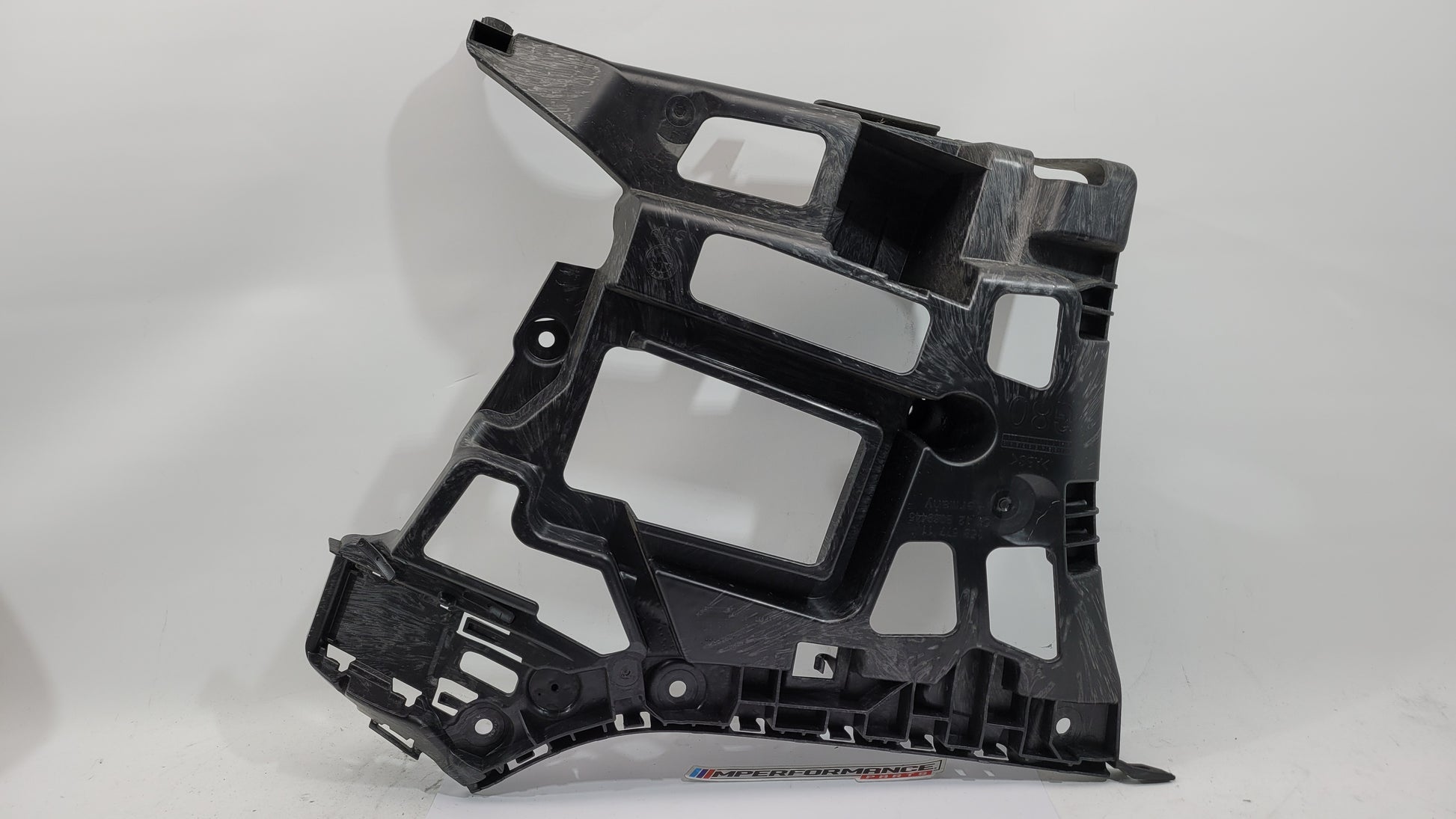 BMW M3 M4 G80 G82 rear left bumper corner bracket, MPerformance.parts replacement part, close-up view showing mounting details