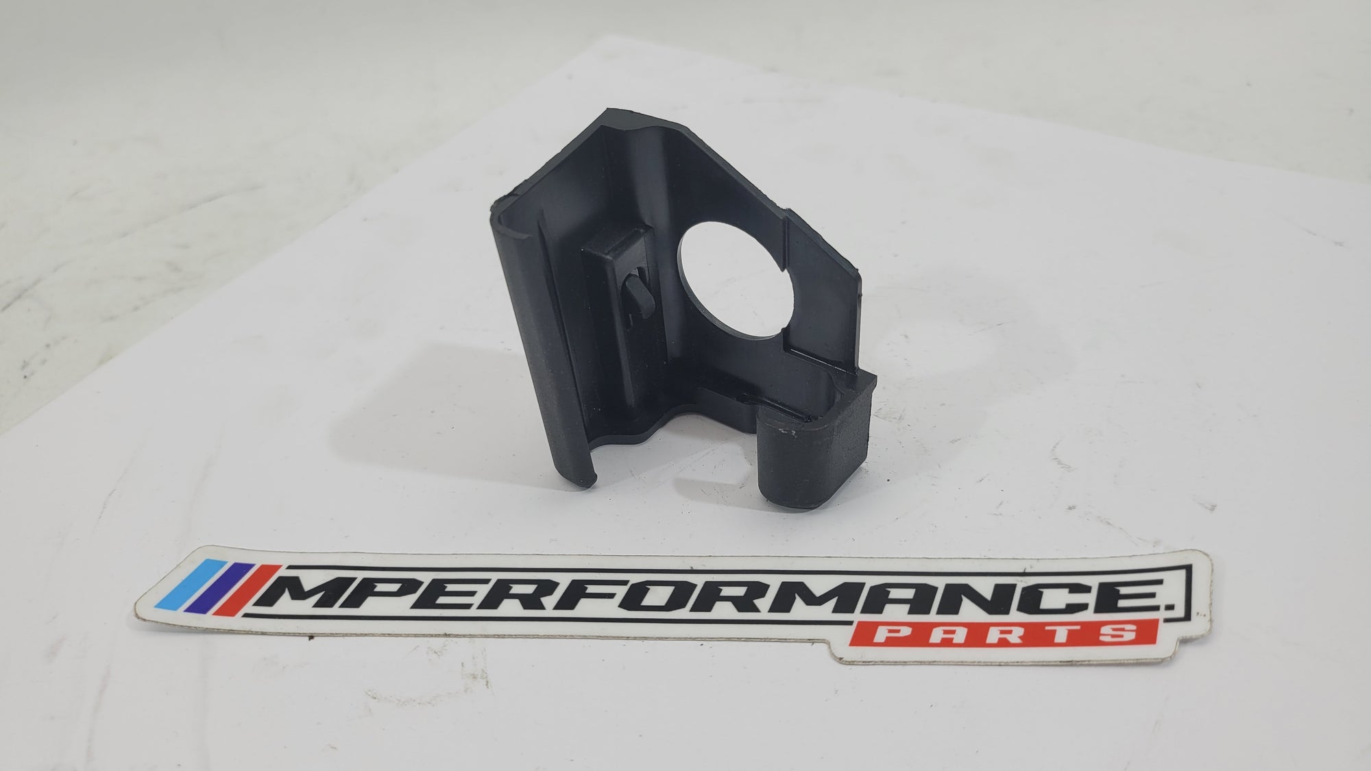 BMW G80 M3 seat rail cover by MPerformance.parts, showing close-up view of the black plastic protective cover on the seat rail.